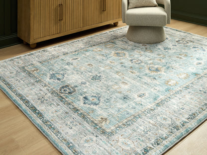 Ocala Furniture Outlet - Ashley Furniture - Ladstoney Rug - 7'6" x 9'6" Area Rug / Teal/Beige/Ochre - R407501