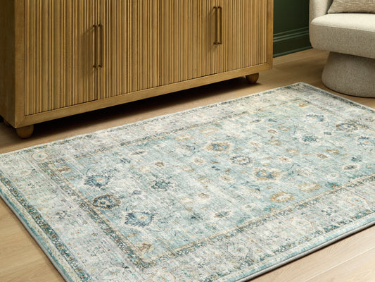 Ocala Furniture Outlet - Ashley Furniture - Ladstoney Rug - 7'6" x 9'6" Area Rug / Teal/Beige/Ochre - R407501